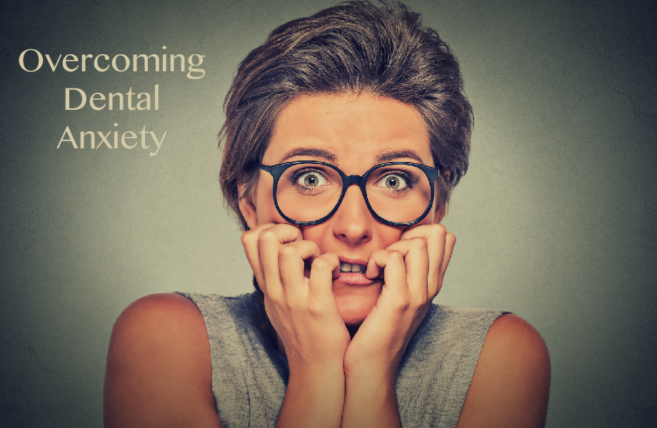 woman in glasses worried about overcoming her dental anxiety