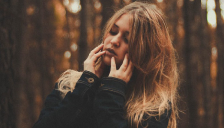 girl holding her jaw with phantom tooth pain