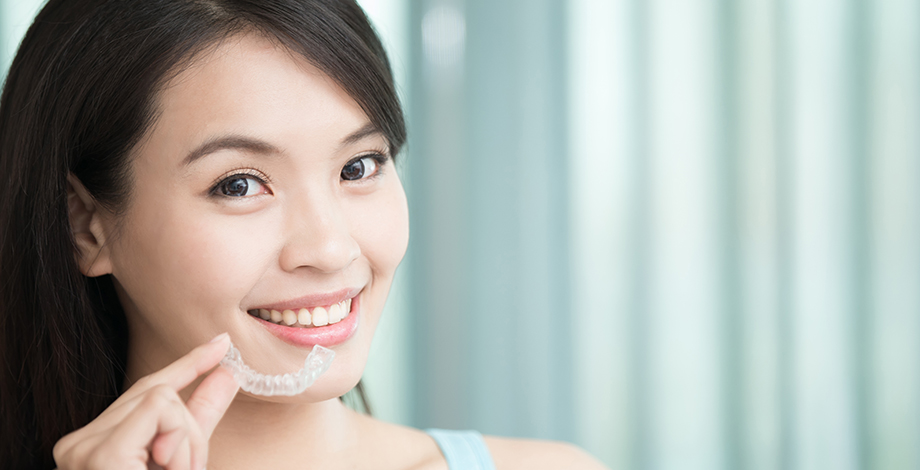 Young asian woman smiling with her clear aligner