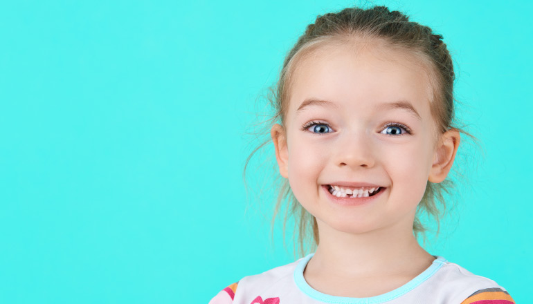 young girl with missing baby teeth